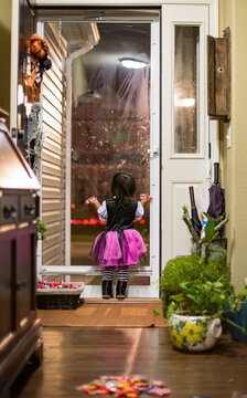 Pirate costume girl standing in doorway on Halloween