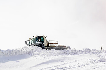 snowcat ratrack with snowplow,grooming machine,remover truck preparing ski slope, winter resort