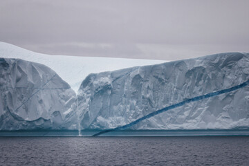 little waterfall over big iceberg