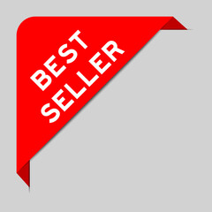 Red color of corner label banner with word best seller on gray background