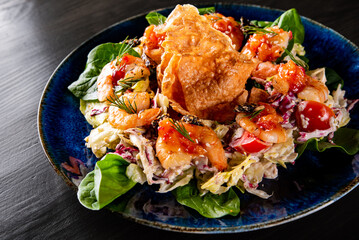 Fresh salad plate with shrimp, tomato, spinach, cabbage and Tangerine Jam in plate on wooden table background