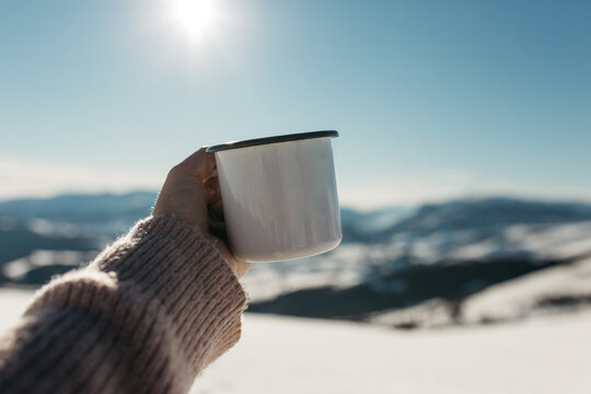 hiker drink tea in mountains