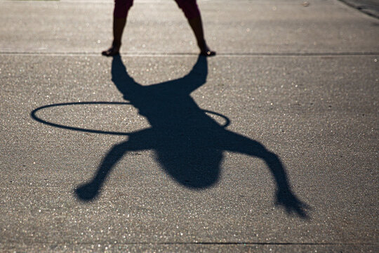 Girl with hula hood on driveway