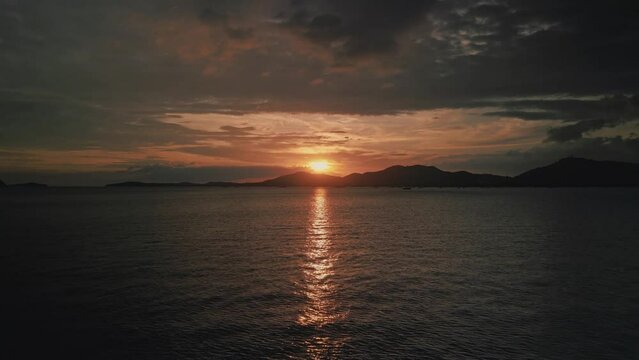 Tropical golden sunset over ocean water aerial view