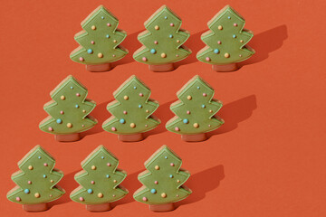 gingerbread cookie of green Christmas Tree on red background.