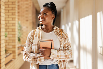 Black woman, college student and thinking about future with books while walking at campus or university. Young gen z female happy about education, learning and choice to study at school building - obrazy, fototapety, plakaty