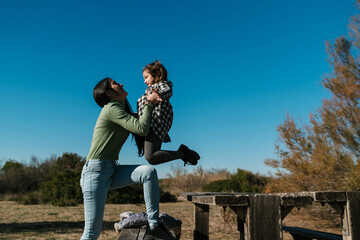 Mother and daughter having fun in countryside