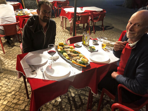 UGC senior father and son having dinner at the restaurant