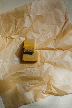 Vegan, artisan cheese in paper wrap.