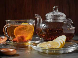 a cup of hot tea with lemon and bagels