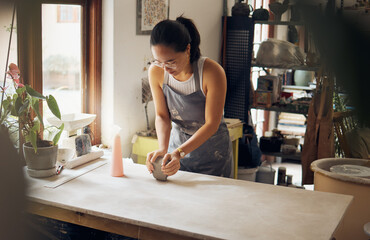 Creative, small business and pottery girl working with clay for idea, inspiration and art process. Creativity, business owner and asian woman focused at artistic workspace in Tokyo, Japan