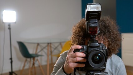 Photographer man taking pictures and video in apartment - real estate home photoshoot for selling...