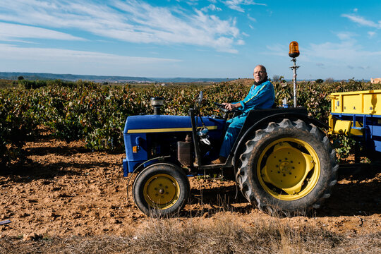 Male farmer driving tractor in field