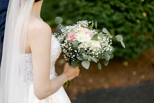 Bride Walking Outdoors and Holding Bouquet 
