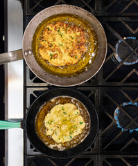Pataniscas de bacalhau frying in pans. Pataniscas are one of the most traditional dishes in Portuguese cuisine.
