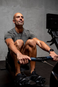 Sportsman exercising on rowing machine