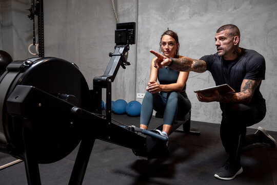 Trainer giving advice to sportswoman