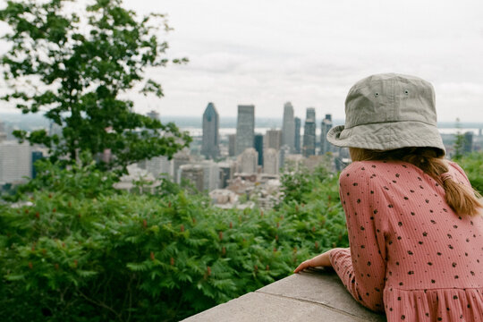 A girl looking at the city of Montreal from the viewing point
