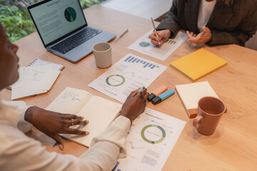 Manager discussing data with colleague and making notes