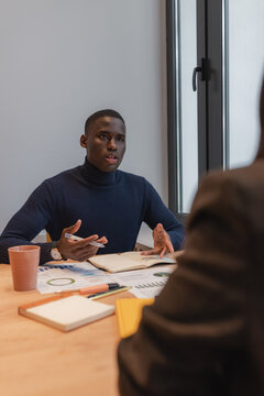 Black manager discussing data with boss