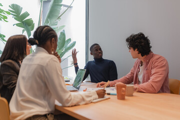 Black manager speaking with coworkers