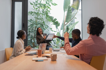 Diverse businesspeople laughing at report