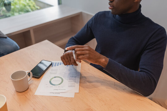 Black manager sitting at table during meeting