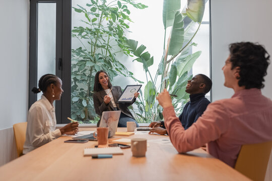 Diverse businesspeople discussing projects and laughing