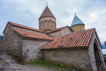 Fototapeta premium Ananuri, Georgia : 20-11-2022 : amazing view of the Ananuri castle complex with church on the Aragvi River in Georgia in a cloudy day. Ananuri Castle is located close Tbilisi.