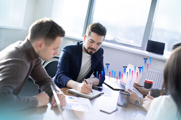 Business people discussing documents and ideas at meeting. brainstorm and 