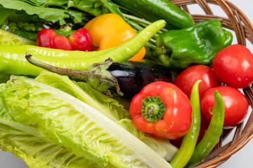close up fresh vegetables in a basket, tomato, cucumber, green pepper, watercress healthy food