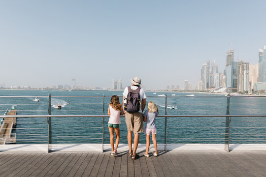 Father and daughter outdoors by the sea in Dubai