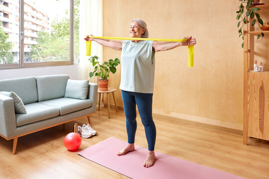 Senior woman exercising with resistance band