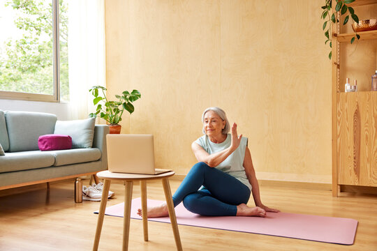 Senior woman doing Seated twist during yoga lesson