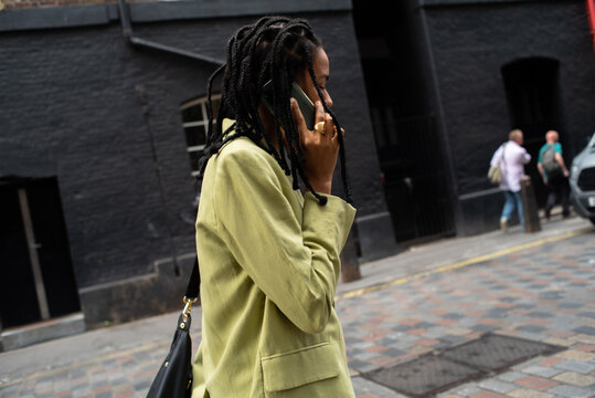 Elegant black businesswoman street phone call