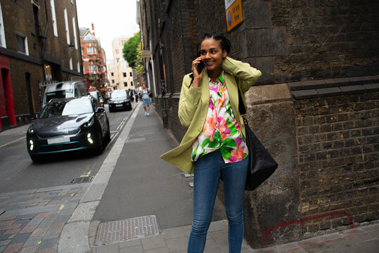 Street lifestyle portrait businesswoman calling 