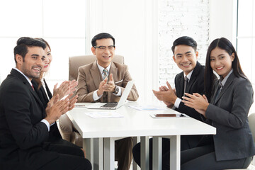 Business, technology, and office concept - Diverse friendly business team meeting for successful targets, excellent work results or job promotion, colleagues clapping hand and cheering team
