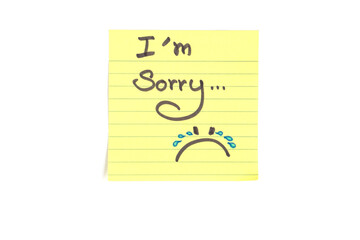 Sheet of yellow paper with text I'm sorry on white background 