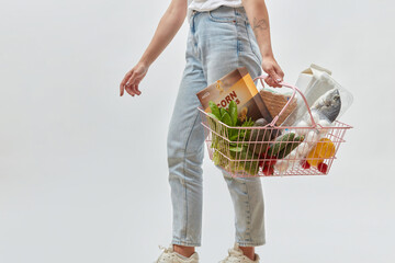 Food purchases held by unrecognizable girl.