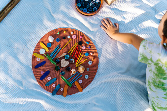 Anonymous child creating decoration during art lesson