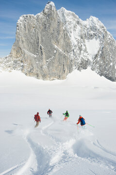 A group of backcountry skiers cross tracks in the Selkirk Mountains, Canada.