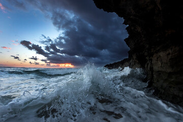 Wave crashing on ocean cliff at sunset, Oahu, Hawaii Islands, USA