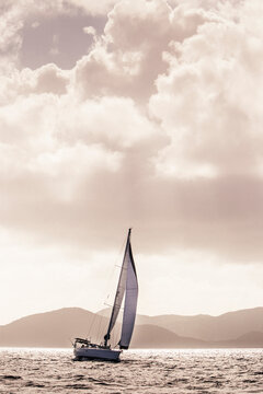 A yatch sails in calm waters in the Caribbean