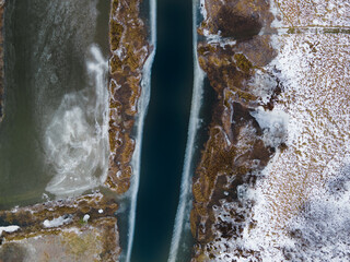 Thawed river. River in winter time. Flooded meadows in winter.