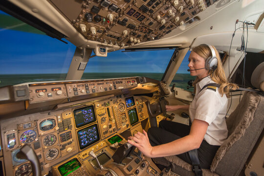 Female pilot in flight simulator during training