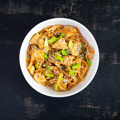 Noodles with vegetables, chicken and mushrooms in bowl. Stir fry pasta. Top view