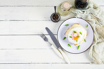 Delicious breakfast. Hot french toast with ham and bechamel sauce - croque madame. Top view