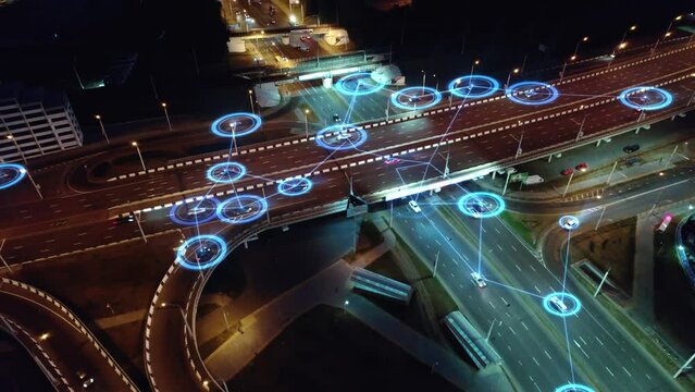 Concept of smart urban transport of the future. Driverless self-driving autonomous cars drive on city evening streets. HUD elements visualizing road scanning and vehicle interaction. 4k footage.