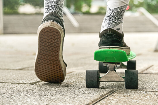 Close-up of guy legs in shorts on an outdoor penny skateboard - Powered by Adobe