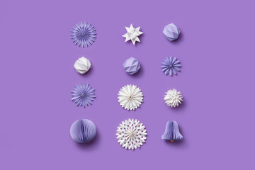 Paper Christmas elements on purple background.